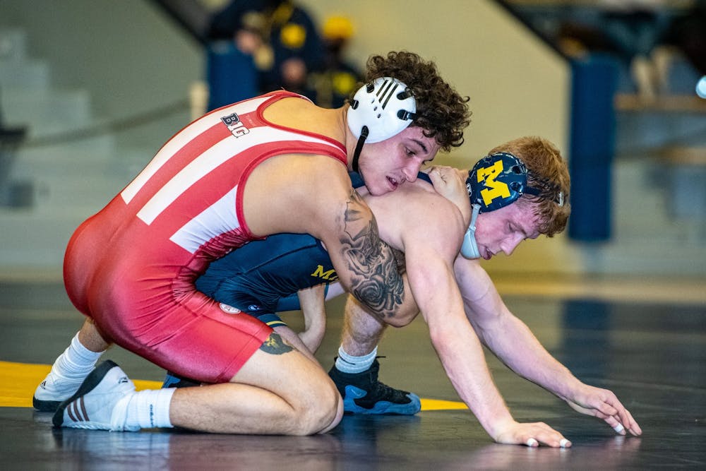 <p>Sophomore Aca Garcia grapples on Sunday in Ann Arbor, Michigan, with Michigan wrestler Jack Medley. Garcia won 11-6 in the 133-pound weight class against Medley, a member of the No. 3 ranked Michigan Wolverines.</p><p></p>