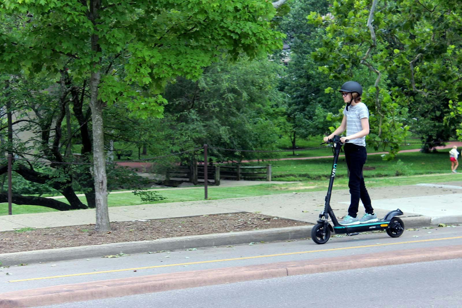 A student rides an e-scooter in a bike lane near the IU campus. 