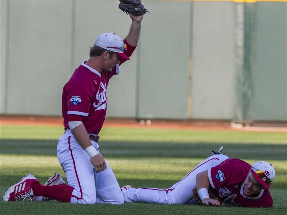 Junior Casey Smith holds up the ball after he collided with sophomore Chad Clark during IU's 1-0 loss to Oregon State at TD Ameritrade Park in Omaha Neb.
