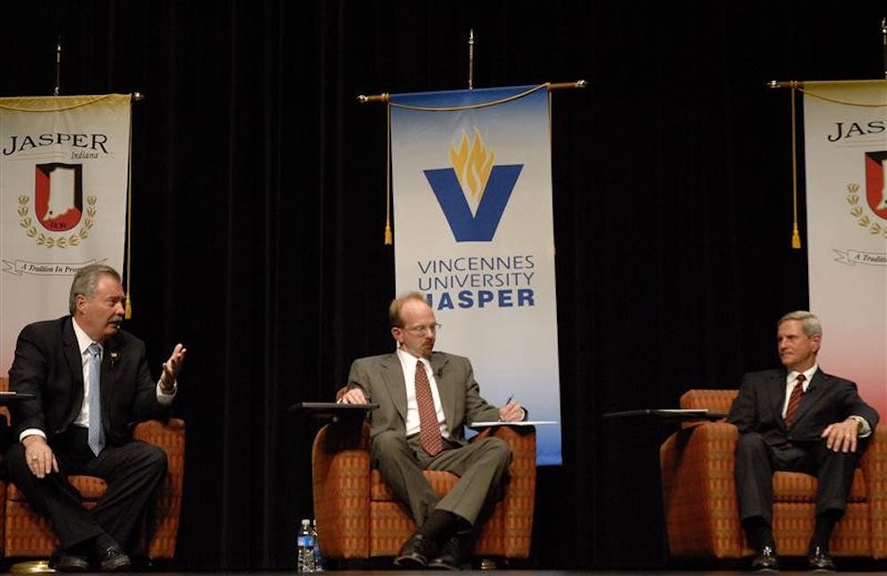 Former Rep. Mike Sodrel, R-9th, left, answers a question from the audience as libertarian candidate Eric Schansberg and Rep. Baron Hill, R-9th listen during a forum on Tuesday night at the Jasper Arts Center Auditorium in Jasper, Ind. All three candidates answered seperately from a panel before taking audience questions.