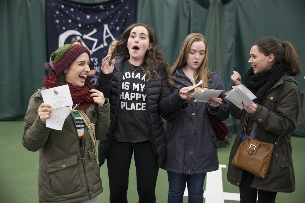 <p>Freshman Ari Scott receives her bid alongside her floor-mates at the Indiana University Tennis Center on Tuesday. The women received their bids together and left with their respective houses on buses.&nbsp;</p>