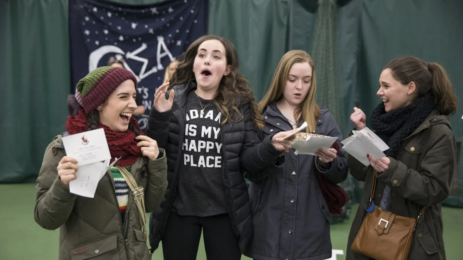 Freshman Ari Scott receives her bid alongside her floor-mates at the Indiana University Tennis Center on Tuesday. The women received their bids together and left with their respective houses on buses. 