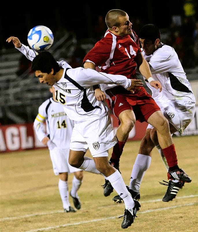 Sophomore forward Neil Wilmarth battles two Michgan players for a header during the Hoosiers 3-0 NCAA Tournament win over the Wolverines Saturday night at Bill Armstrong Stadium. No. 6 IU will take on No. 3 St. John's on Saturday in the quarterfinals.
