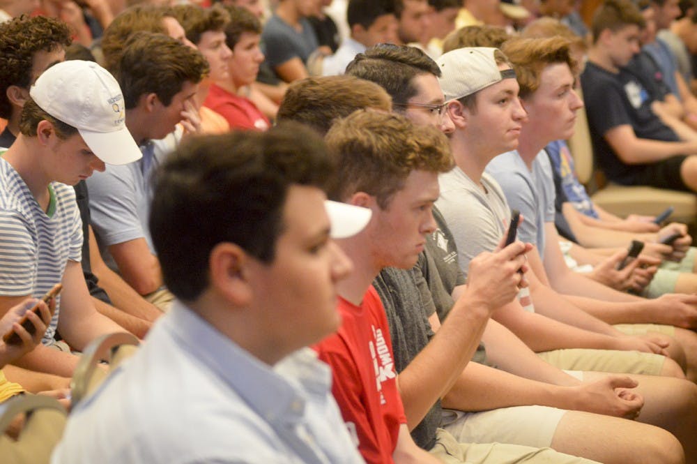 Freshmen prepare to register for fraternity rush during the Greek Orientation Seminar Tuesday evening at Alumni Hall. Hopeful first year students were informed on house tours, rush dues, and were told to beware of “fake” fraternities recruiting on campus such as the now infamous Alpha Tau Omega.
