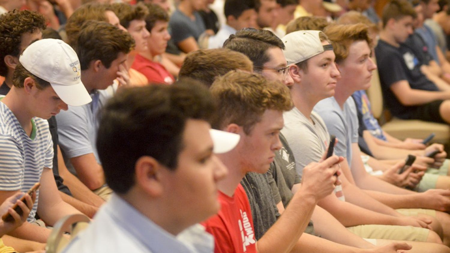 Freshmen prepare to register for fraternity rush during the Greek Orientation Seminar Tuesday evening at Alumni Hall. Hopeful first year students were informed on house tours, rush dues, and were told to beware of “fake” fraternities recruiting on campus such as the now infamous Alpha Tau Omega.