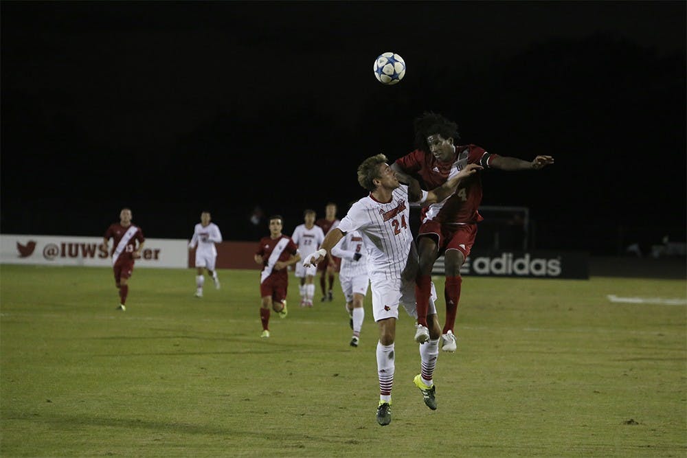 Senior Forward Femi Hollanger-Janzen fights for the ball during IU's game against Louisville Tuesday night at the Bill Armstrong Stadium.
