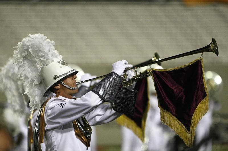 A member of the Phantom Regiment plays the opening fanfare for the corps' show "Spartacus" during DCI Quarterfinals competition Thursday night at Memorial Stadium.
