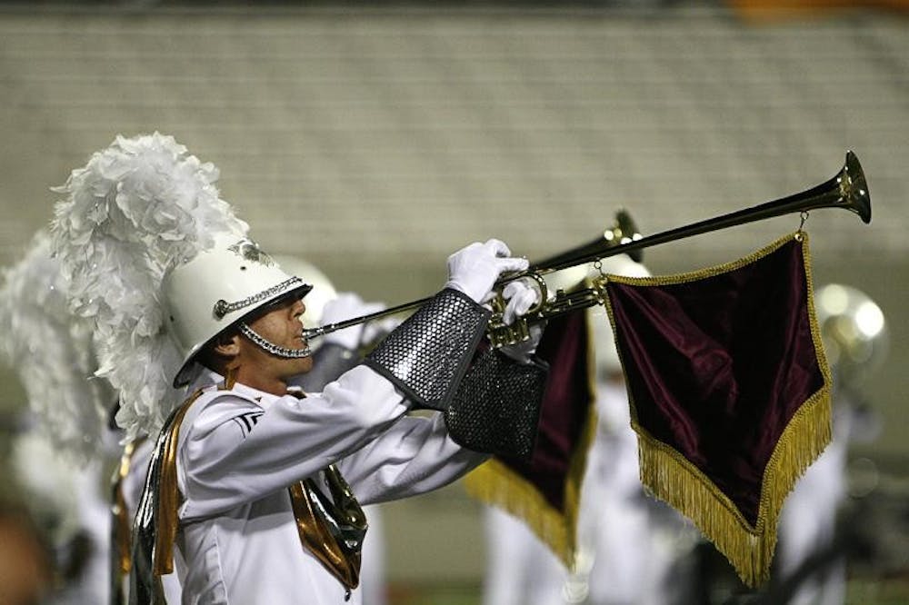A member of the Phantom Regiment plays the opening fanfare for the corps' show "Spartacus" during DCI Quarterfinals competition Thursday night at Memorial Stadium.