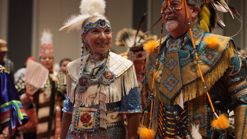 A couple participates in a group dance during the IU Traditional Powwow on April 9, 2022, at the Marching Hundred Hall. The Office of the Vice President for Diversity, Equity, and Multicultural Affairs will host a presentation at the Sample Gates to celebrate the Indigenous People&#x27;s Day proclamation on Oct. 10.
