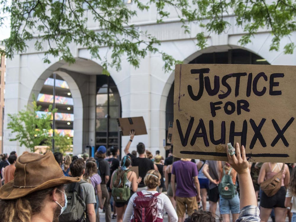 A protester holds up a sign July 6 in front of the Charlotte Zietlow Justice Center. Vauhxx Booker was the victim of a racist attack July 4 near Monroe Lake.