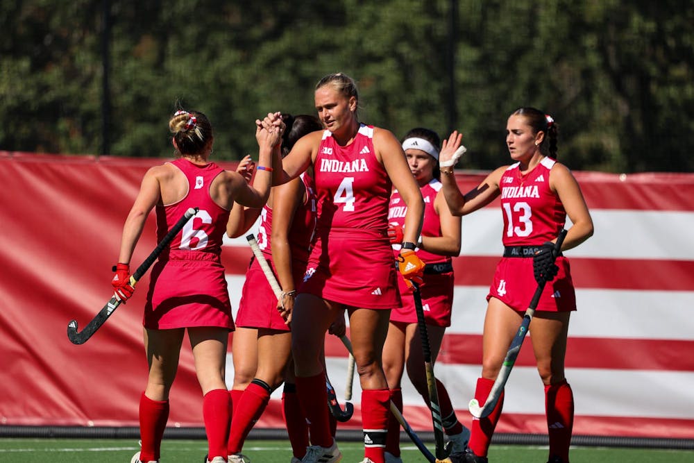 The team celebrates their win with highfives after a game versus Berkeley Oct. 18,2024 at Deborah Tobias Field in Bloomington. The game resulted in a win for IU 2-0. 