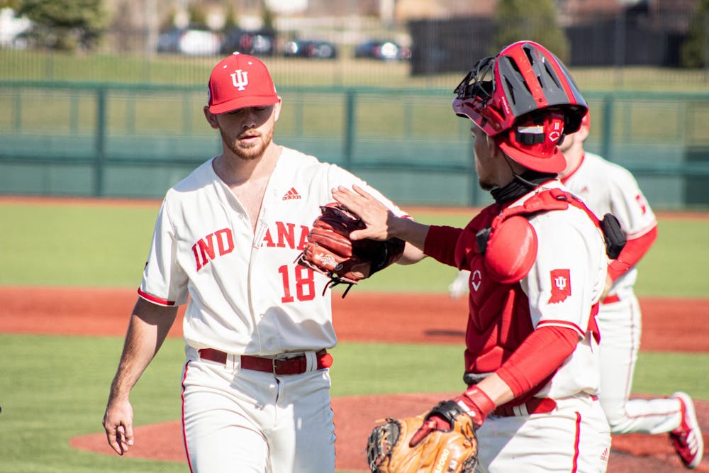 <p>Redshirt senior catcher Collin Hopkins high fives senior pitcher Braden Scott during a game against Purdue on Saturday at Bart Kaufman Field. The Hoosiers won two of three games against the Purdue Boilermakers this weekend.</p>