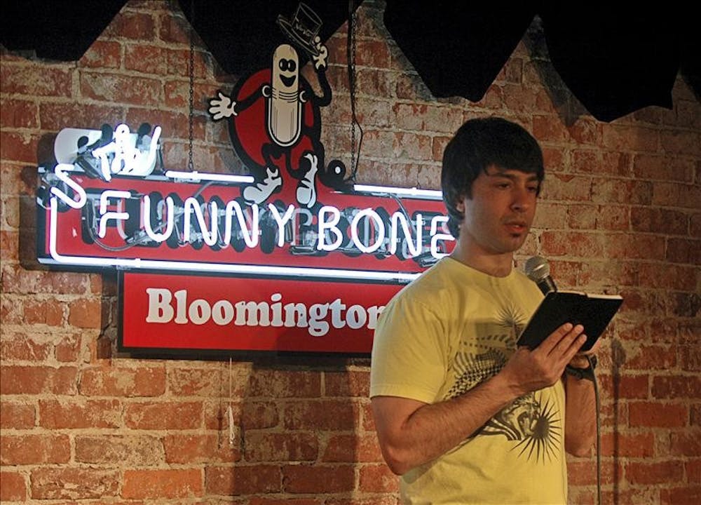 Comedian Arj Barker consults his book of jokes Thursday evening at The Funny Bone. Barker was in town for five performances over the weekend.