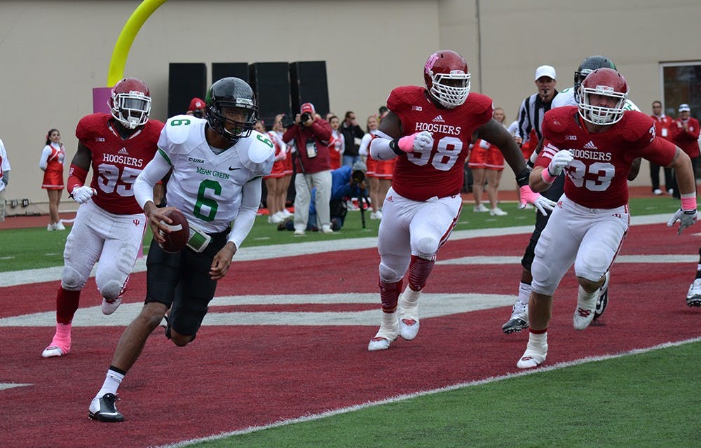 The IU defense chases Mean Green quarterback Dajon Williams out of the pocket during IU's game against North Texas on Saturday at Memorial Stadium.