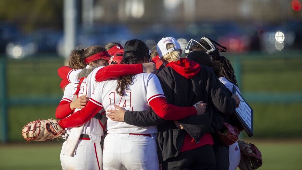 Indiana softball gathers together during a timeout March 28, 2023, at Andy Mohr Field. Indiana&#x27;s coaching staff is among 10 finalists for the National Coaching Staff of the Year award.