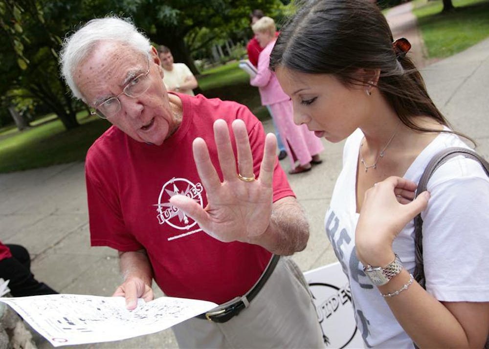 Ken Gros Louis assists then-freshman Madalyn Warshawsky during the first day of classes in 2009. Gros Louis died Thursday at the age of 80.