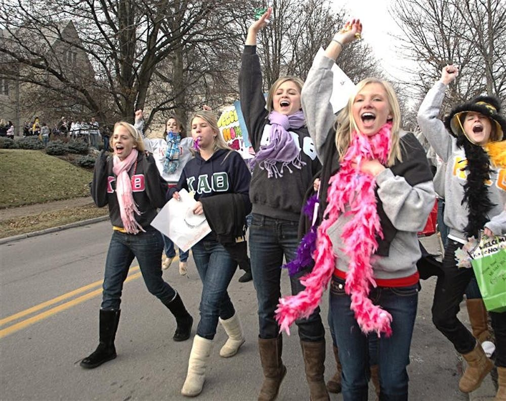 Sisters of Kappa Alpha Theta Sorority cheer Sunday afternoon in the middle of Woodlawn Avenue, awaiting their new pledges. Sunday marked the end of Formal Recruitment.