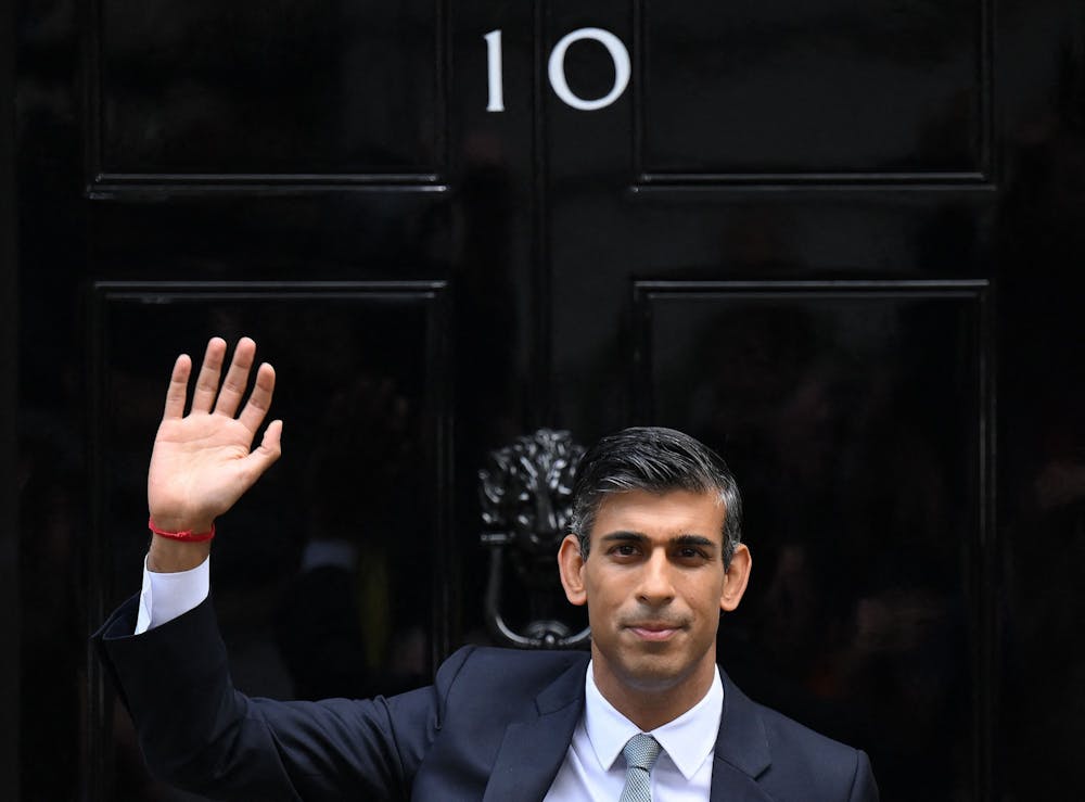<p>Britain&#x27;s newly appointed Prime Minister Rishi Sunak waves after delivering his first speech as prime minister Oct. 25, 2022, at 10 Downing St. in central London.</p>
