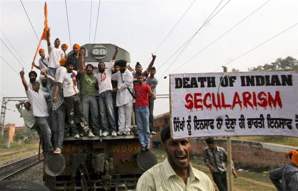 Sikh activists stop a train during a protest to mark the 25th anniversary of the 1984 riots against Sikhs on Tuesday in Jalandhar, India. 2,000 people were killed in the 1984 anti-Sikh riots after the murder of then-prime minister Indira Gandhi by her two Sikh bodyguards. 