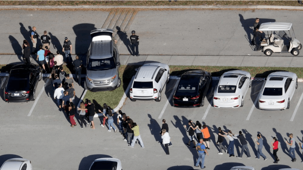 Students are evacuated by police out of Stoneman Douglas High School after a shooting on Wednesday, Feb. 14, 2018, in Parkland, Florida.