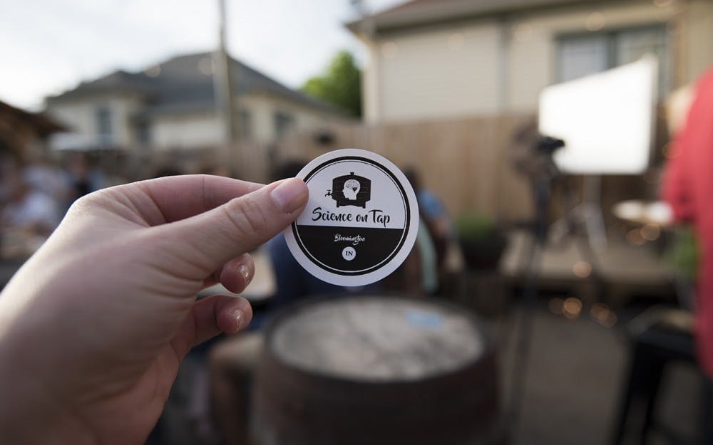 Sean Buehler handed out stickers for Science on Tap on Tuesday night. This was the last event for the year.