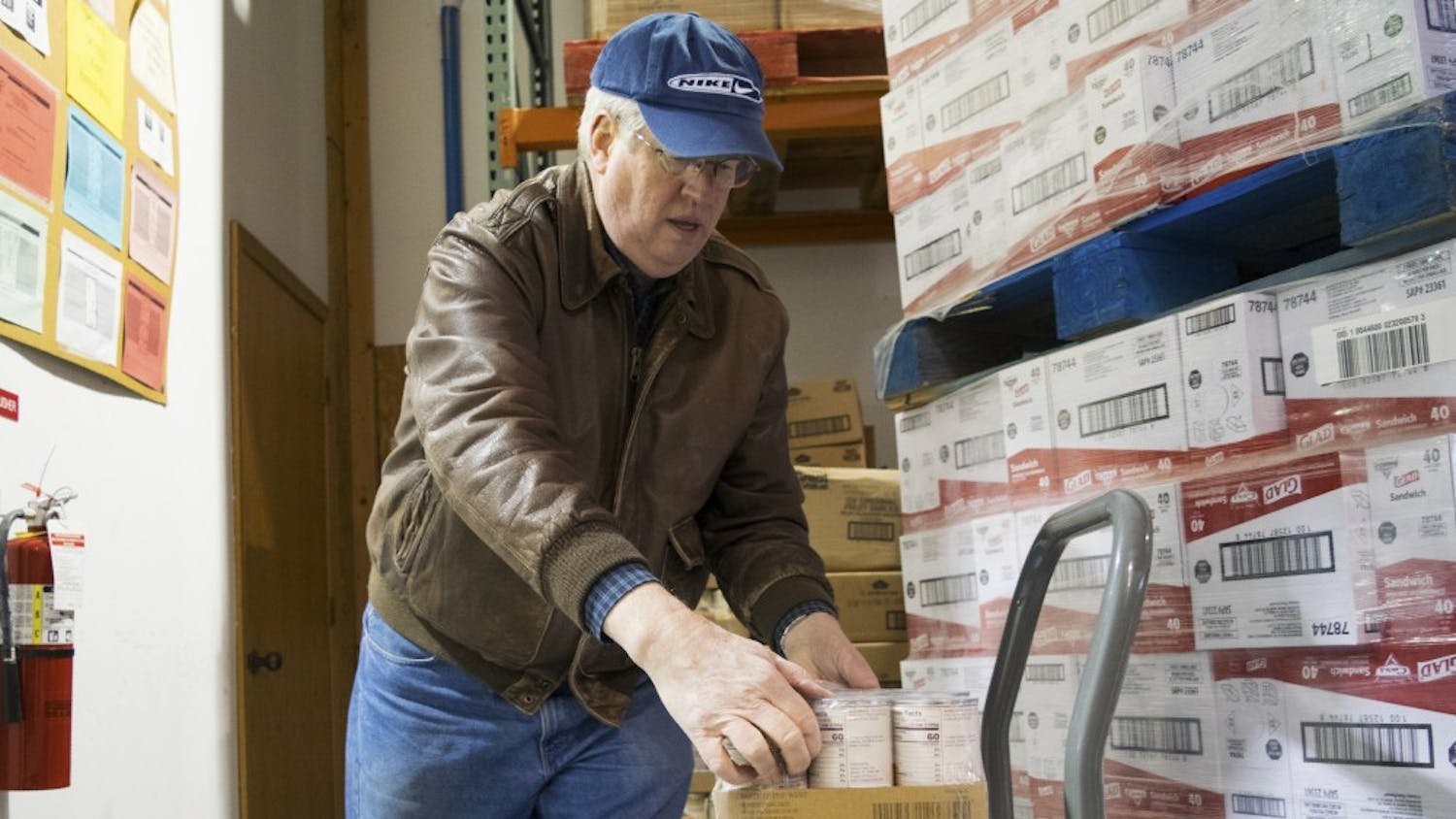 First United Methodist Church volunteer Steve Ulrey unloads cans of peaches on Wednesday at the Hoosier Hills Food Bank. The food bank serves six counties, including Monroe County, and will celebrate its 35th anniversary on Saturday.
