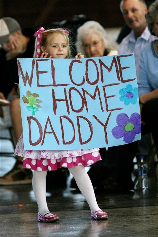 Julianne Egan, 5, daughter of Warrant Officer Brad Egan of Bloomington, waits for her father to march into Building 9 at Stout Field on Wednesday in Indianapolis. Brad Egan is one of the members of the Indiana National Guard 76th Infantry Brigade Combat Team that returned to Indianapolis on Wednesday after serving in Iraq since March. 