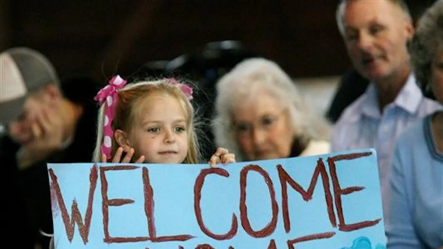 Julianne Egan, 5, daughter of Warrant Officer Brad Egan of Bloomington, waits for her father to march into Building 9 at Stout Field on Wednesday in Indianapolis. Brad Egan is one of the members of the Indiana National Guard 76th Infantry Brigade Combat Team that returned to Indianapolis on Wednesday after serving in Iraq since March.