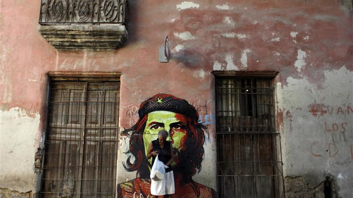 A woman walks past a graffiti depicting Argentine-born revolutionary hero Ernesto "Che" Guevara on Wednesday in Havana. Cuba marks the 41st anniversary of "Che" Guevara's death on Oct. 8, although he was killed on Oct. 9, 1967 in the town of La Higuera, Bolivia.