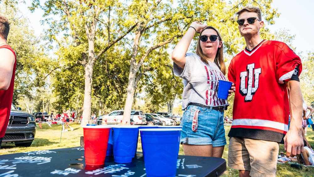 Senior Rachael Sebonia and Dylan Barnes, 23, play a game of beer pong Sept. 11, 2021 at the Indiana Tailgate Fields.