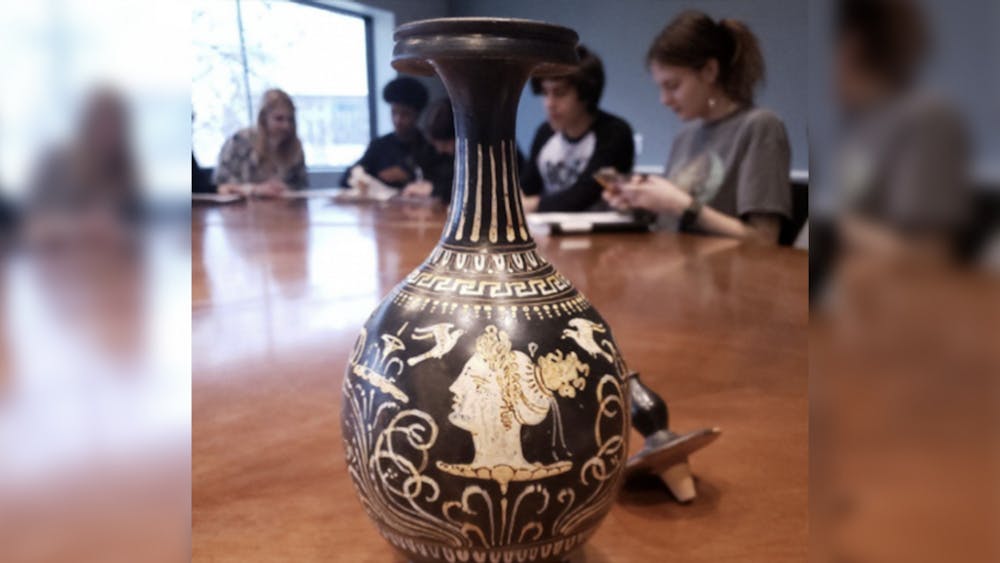 A student-curated piece created with a head of a woman decorated with doves and flowers is pictured. The &quot;Life and Legend: Storytelling and Greek Pottery&quot; exhibit opens May 4, 2023.