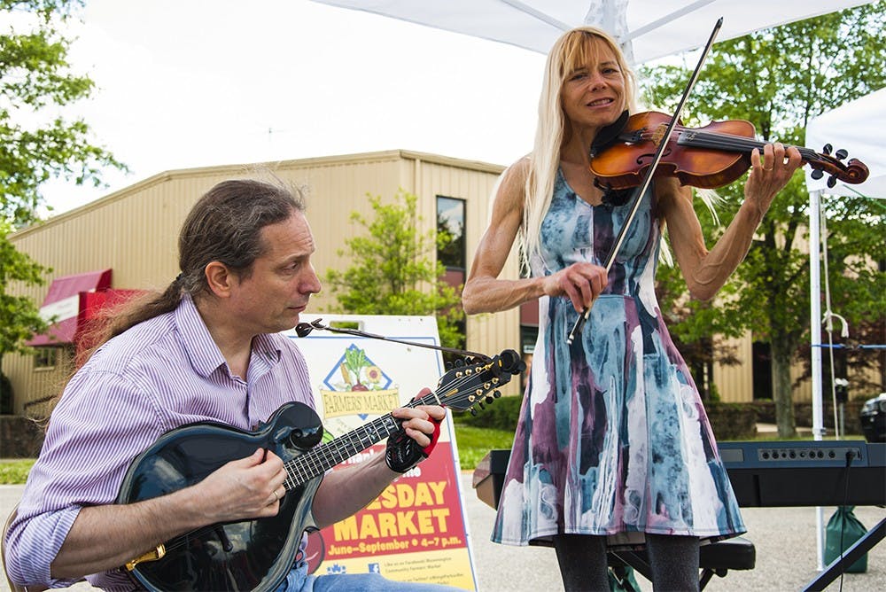 John Paolillo, left, and Twy Bethard perform on Tuesday afternoon at Bloomington community farmer's market.They focused on tight, innovative arrangements of traditional and modern tunes, allowing both musicians room to improvise.