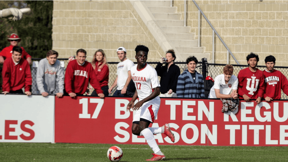 Junior forward Herbert Endeley looks to pass the ball against Northwestern on Nov. 10, 2021, at Bill Armstrong Stadium. Indiana men's soccer earned the No. 15 seed in the NCAA Tournament.