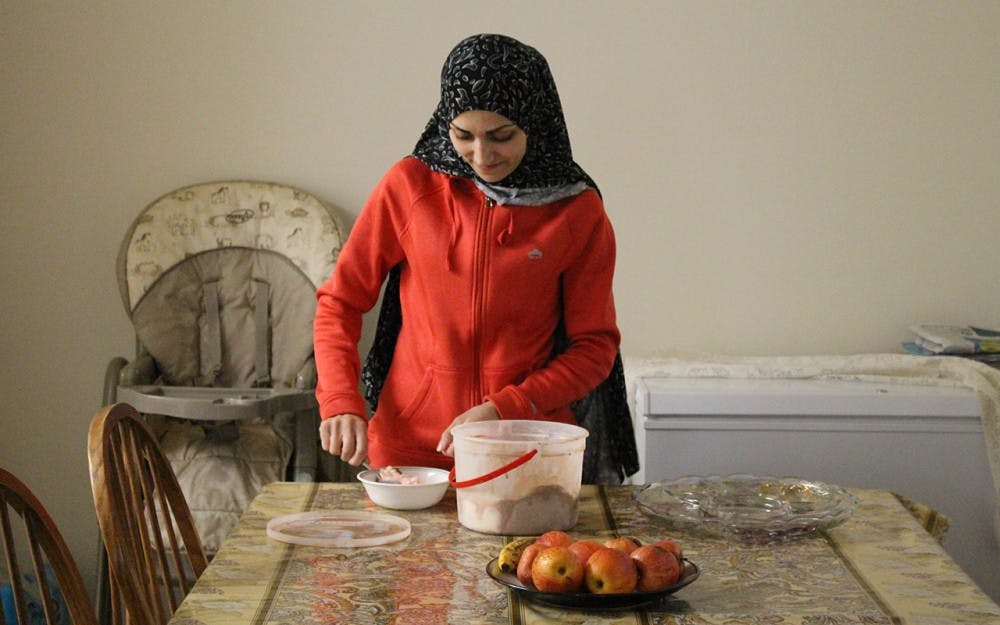 Duha Lababidi scoops ice cream for her youngest daughter, Remas. Duha and her family waited nine months to hear whether they'd be able to join her brother in the United States. Following the recent immigration ban, she&nbsp;has little hope that her father will be resettled with them.