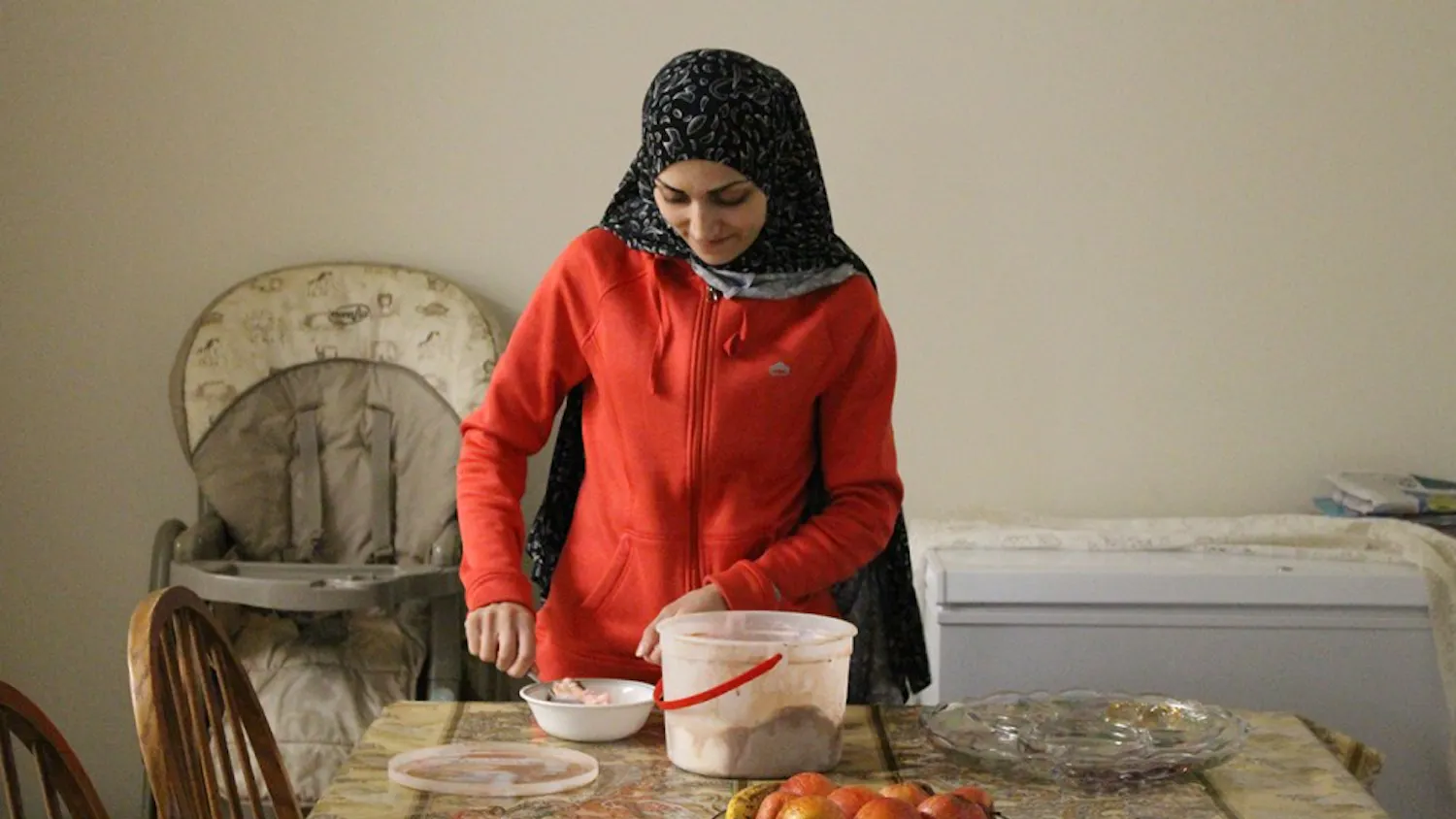 Duha Lababidi scoops ice cream for her youngest daughter, Remas. Duha and her family waited nine months to hear whether they'd be able to join her brother in the United States. Following the recent immigration ban, she has little hope that her father will be resettled with them.