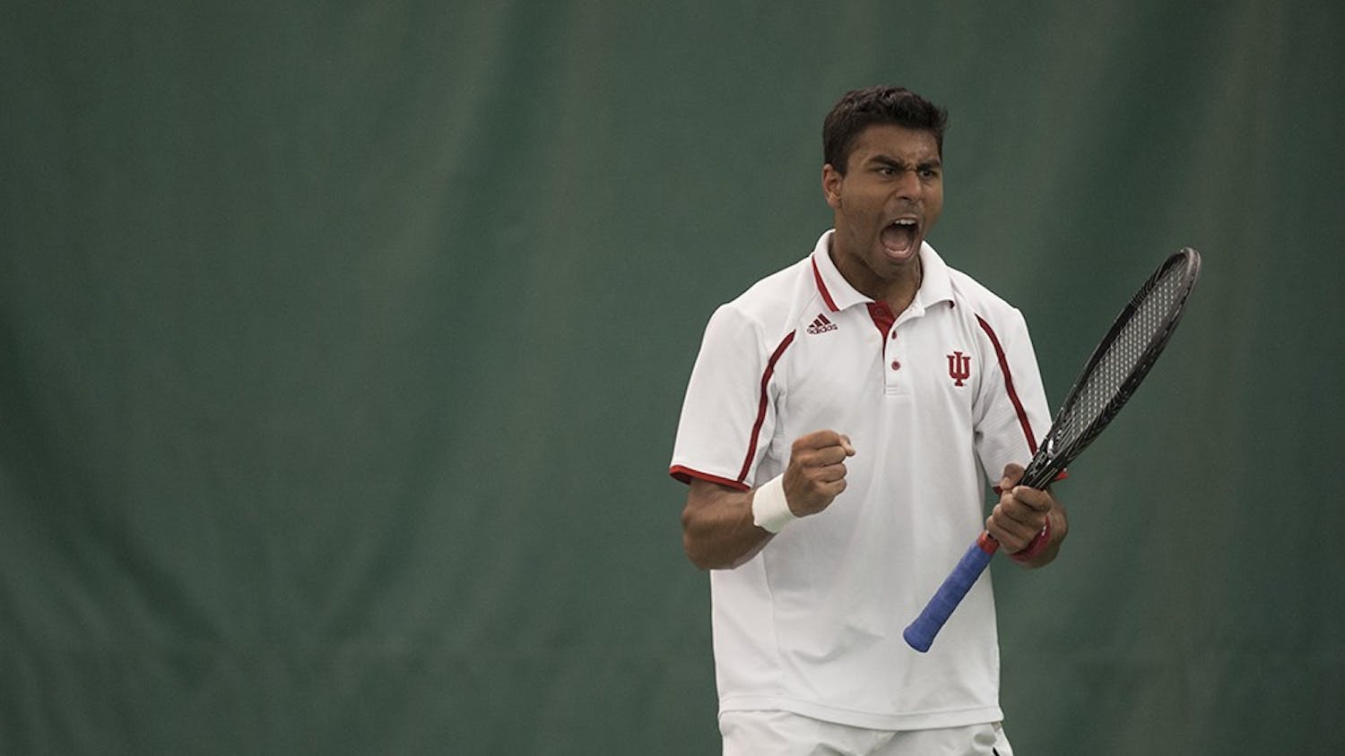 IU freshman Raheel Manji lets out a triumphant scream after scoring a point against John Mullane, a junior from Michigan State University, on Sunday at the IU Tennis Center. Manji won the match 6-4, 6-0.