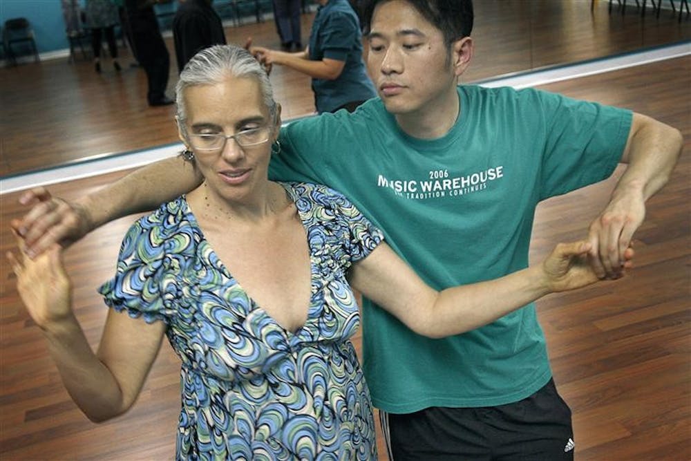 Catalina Bartlett and Gunnson Trey practice dance moves during Intermediate Salsa classes Tuesday night at Panache School of Ballroom and Social Dance. 