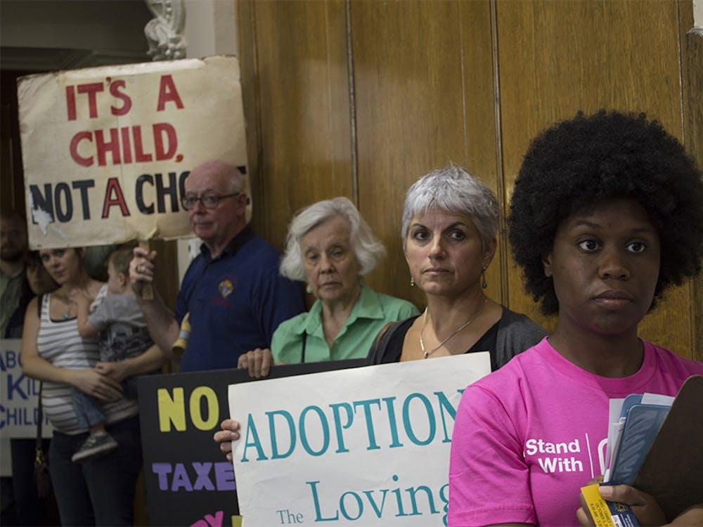 Wanda Savala, Community Engagement Coordinator with Planned Parenthood in Indiana and Kentucky, stands in front of protesters on Tuesday in a county council meeting. The council voted 6-1 to use service grant money to help fund Planned Parenthood.