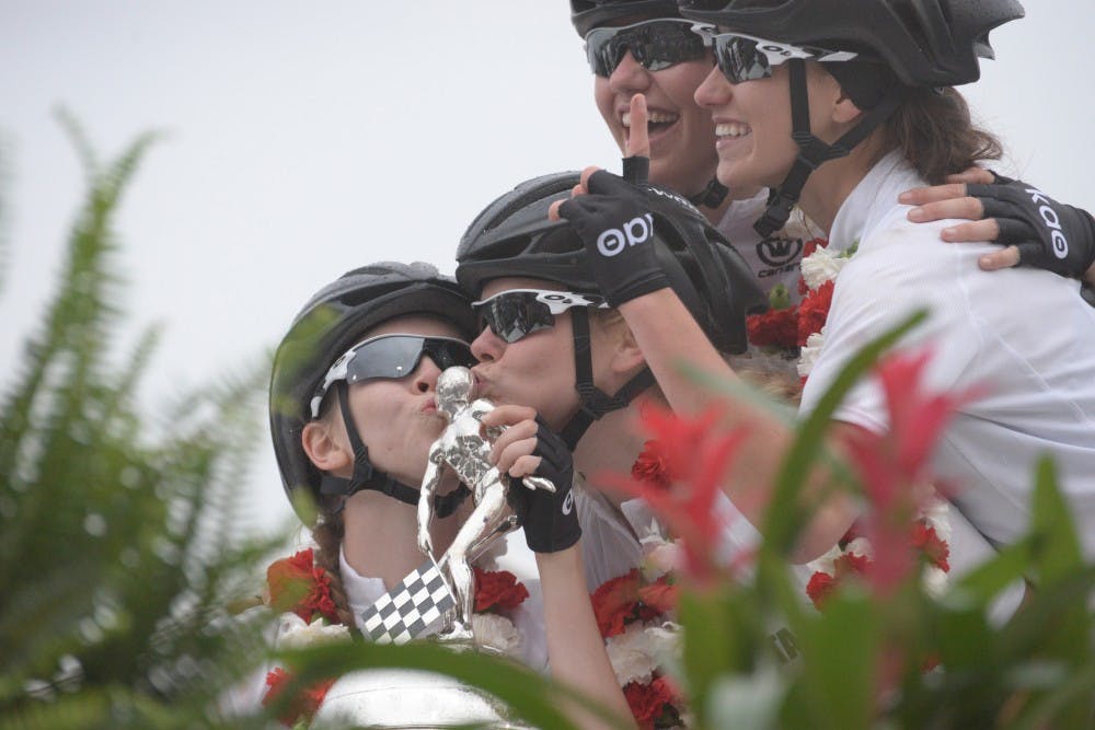 Kappa Alpha Theta riders kiss the trophy after winning the 30th running of the women's Little 500 race Friday afternoon at Bill Armstrong Stadium.&nbsp;