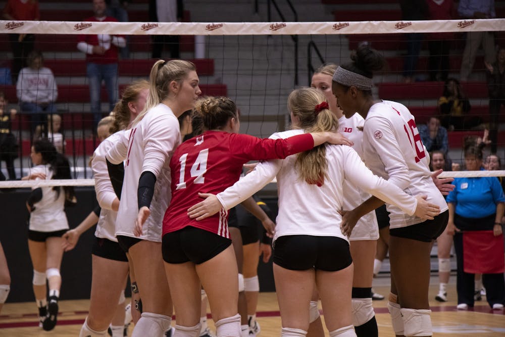 <p>Indiana volleyball players confer between points during the fifth set against Iowa Oct. 26 at Wilkinson Hall. The Hoosiers play Penn State and Minnesota this weekend.</p>
