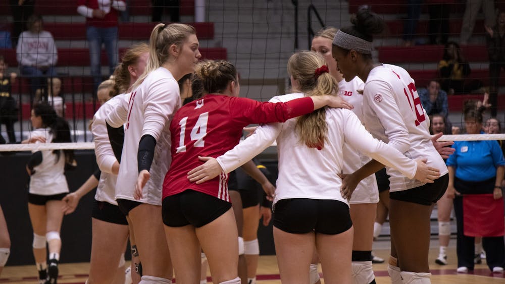 Indiana volleyball players confer between points during the fifth set against Iowa Oct. 26 at Wilkinson Hall. The Hoosiers play Penn State and Minnesota this weekend.