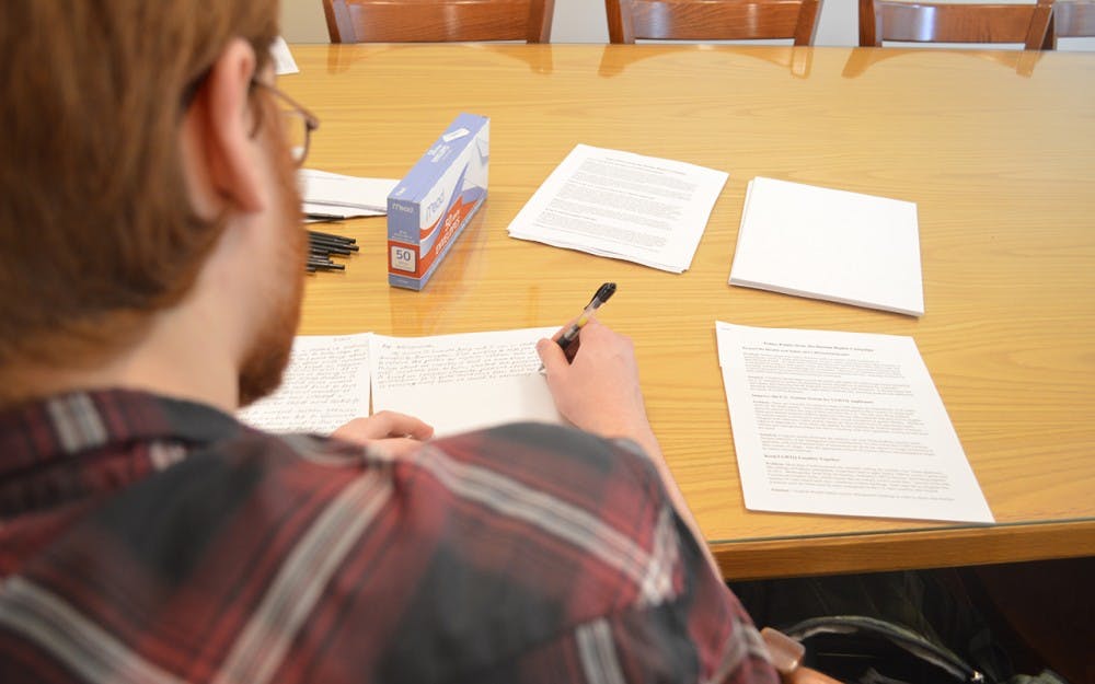 Senior Samuel Young writes letters to legislators to advocate for inclusive reform Tuesday evening at the Canterbury House. He also wrote letters about&nbsp;current immigration policies affecting LGBT people.&nbsp;&nbsp;