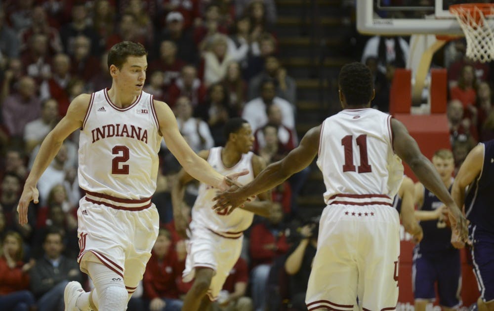 Redshirt senior guard Nick Zeisloft high fives senior Kevin "Yogi" Ferrell during the game against Northwestern on Saturday at Assembly Hall.