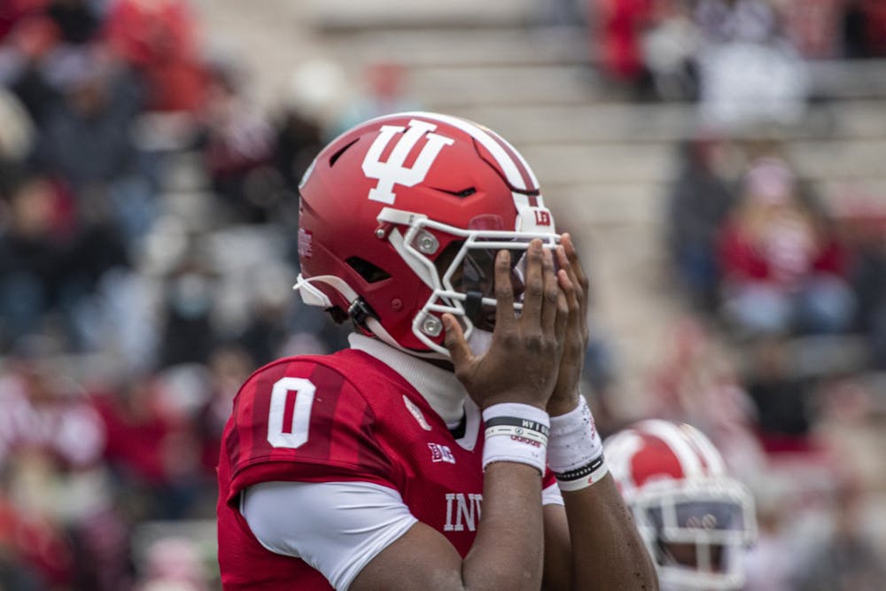 Then-freshman quarterback Donaven McCulley covers his face after fumbling the opening snap against Rutgers on Nov. 13, 2021, at Memorial Stadium.