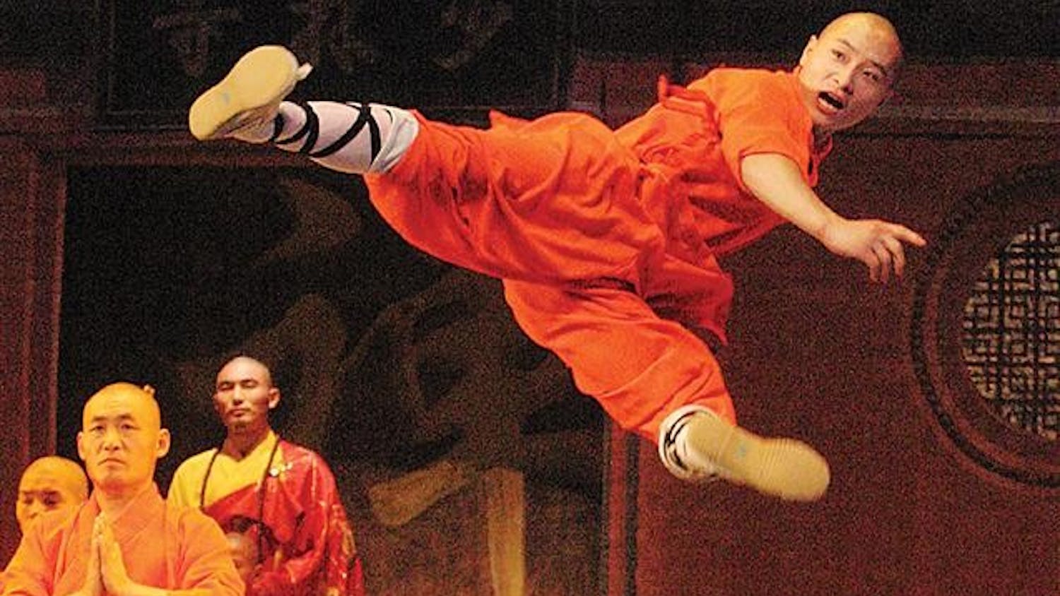 A member of the Shaolin Warriors performs a flying kick in the IU Auditorium. 