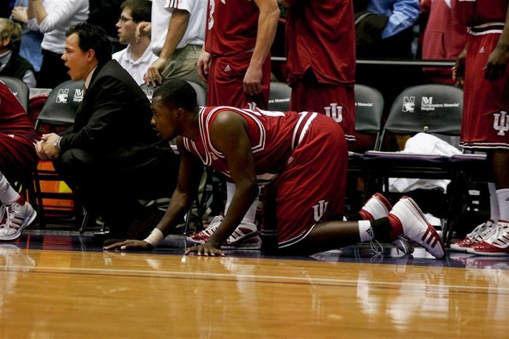 IU Strength and Conditioning Coach Jeff Watkinson and freshman guard/forward Malik Story react to a play during the final moments of the Hoosiers’ loss to the Northwestern Wildcats on Wednesday evening in Evanston, Ill. 