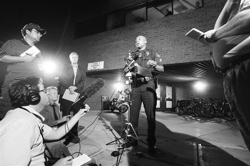Aurora Police Department Detective, Marcus Dudley, speaks to the media during a press conference at the Aurora Police Department in Aurora, Colo., on Monday. Federal authorities are looking into reports that a man arrested after officers found rifles, ammunition and drugs in his truck might have made threats against Barack Obama, officials said Monday. 