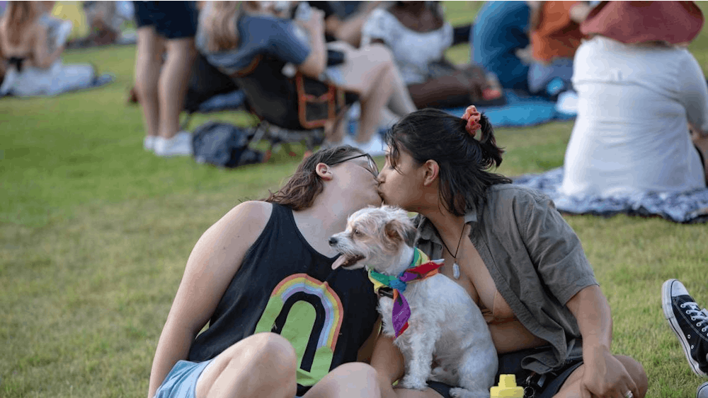 Lindy Jenkins and Jada Bustamante share a kiss before a performance begins during Trinity Pride on June 25, 2022, at Magnolia Green Park. People wanting to listen to emo music can listen to emo hardcore band the Nova Twins and plain hardcore band Fever 333. 