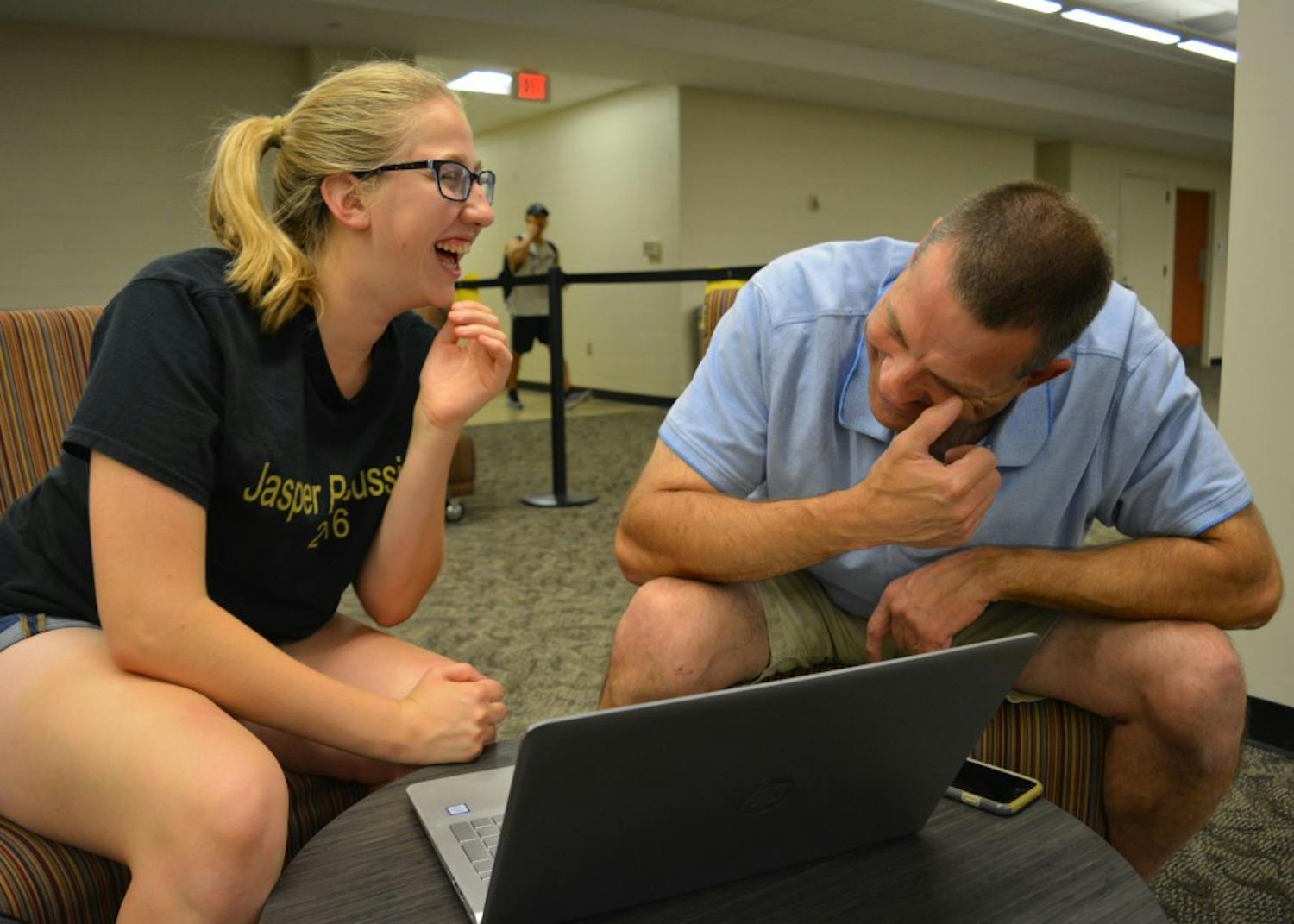 Freshman Elizabeth Ketzner and her father, Brian Ketzner, laugh while listening to a recording of Elizabeth's grandfather in Wells Library on Oct. 3. Because her grandfather died when Elizabeth was a baby, she had no memory of what he sounded like.