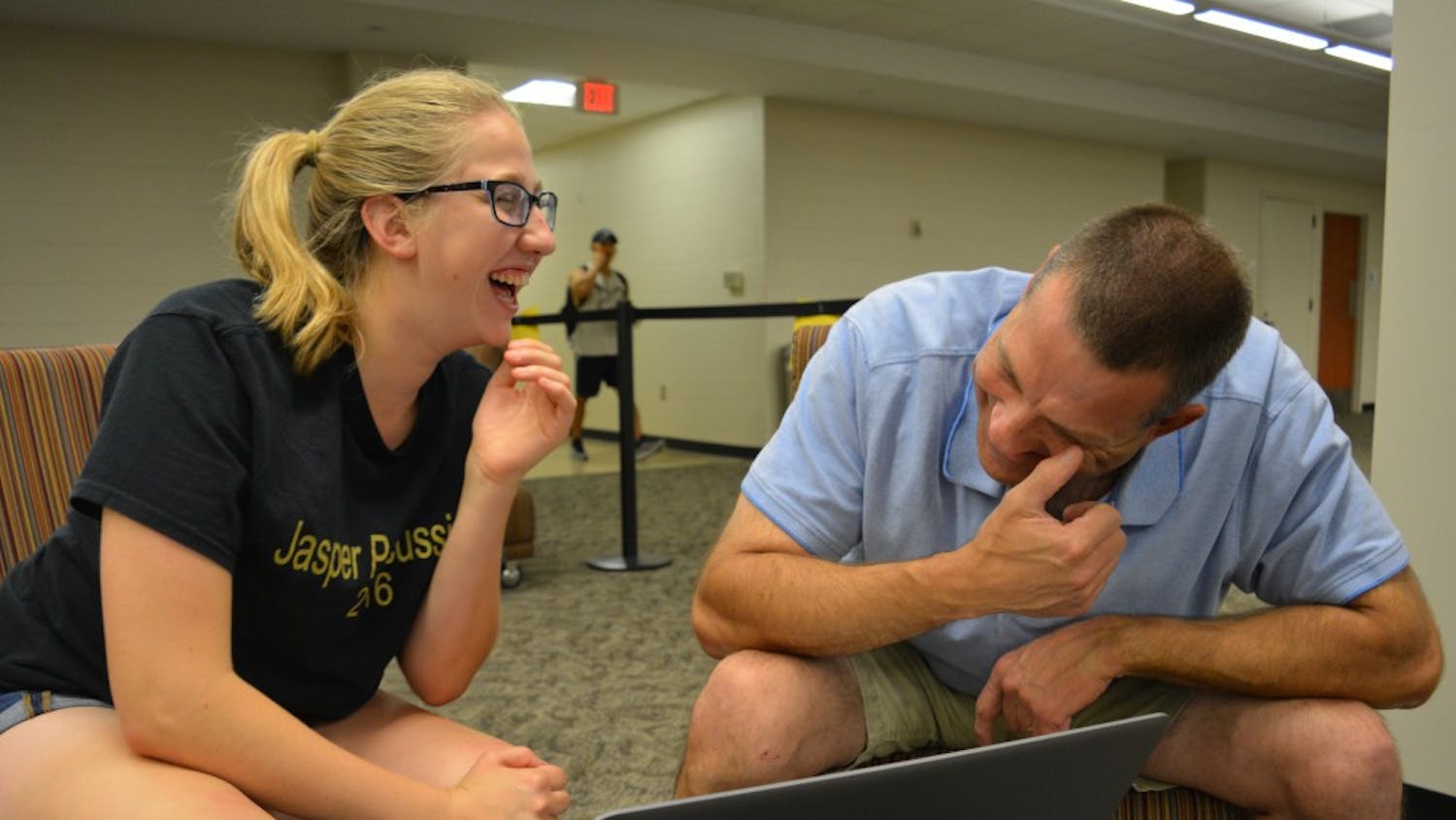 Freshman Elizabeth Ketzner and her father, Brian Ketzner, laugh while listening to a recording of Elizabeth's grandfather in Wells Library on Oct. 3. Because her grandfather died when Elizabeth was a baby, she had no memory of what he sounded like.
